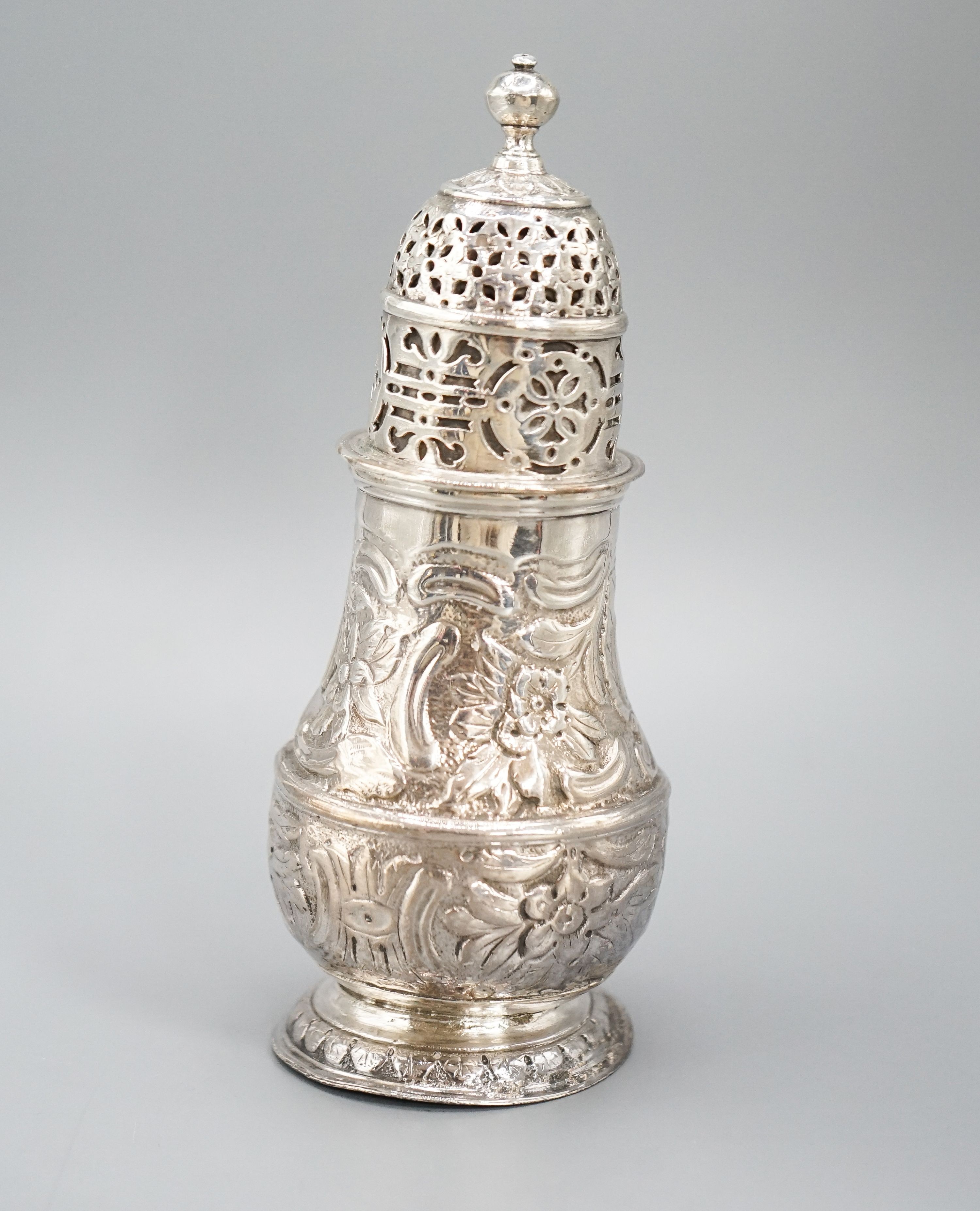 A George I silver sugar caster, with later? embossed decoration, Charles Adam, London, 1716, 13.5cm, 4.5oz.
